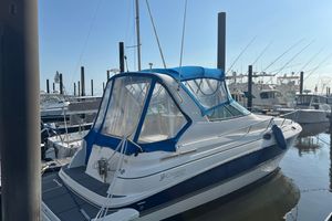 Cruisers Yachts 280 CXi Express 2005 Cruisers Yachts 280 CXI docked at marina, featuring blue canopy and sleek design.