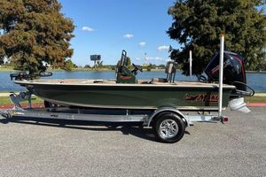 Mako 18 Pro Skiff Backwater Edition 2026 Mako 18 Pro Skiff Backwater Edition on trailer by a lake.