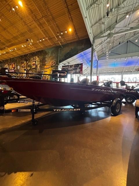 Tracker Super Guide V-16 T 2025 Tracker Super Guide V-16 T boat displayed in a showroom with ambient lighting.