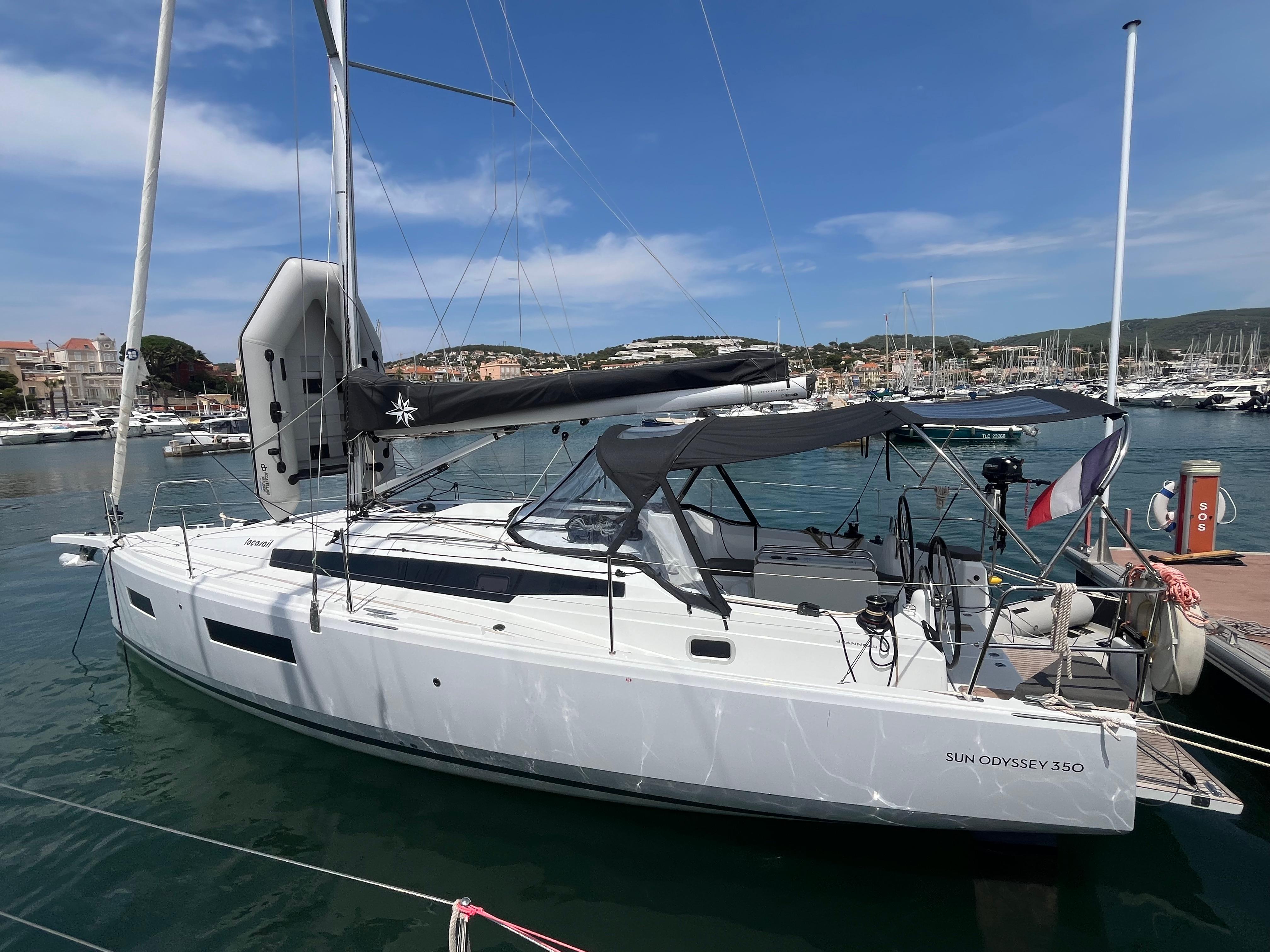 Jeanneau Sun Odyssey 350 2025 Jeanneau Sun Odyssey 350 sailboat docked in a marina under clear blue skies.