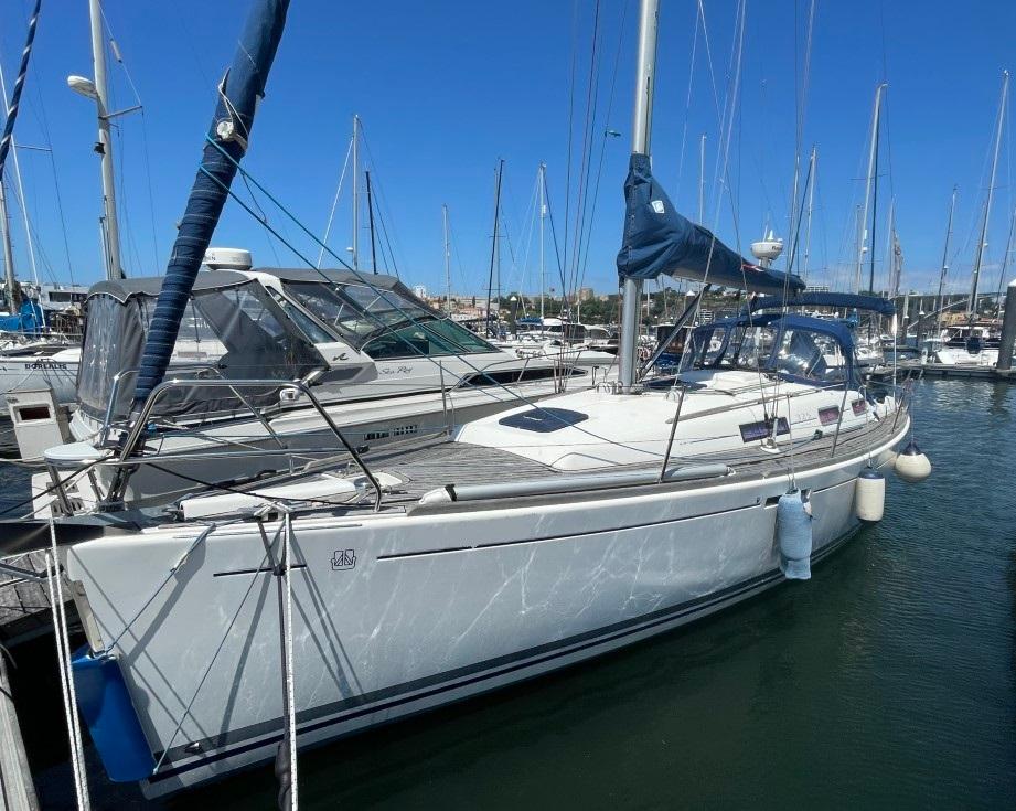 Dufour DUFOUR 325 GL 2009 Dufour 325 GL sailboat docked in a marina under clear blue skies.