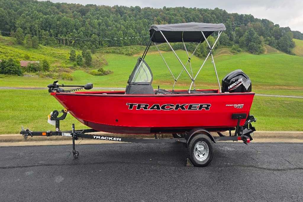 Tracker Pro Guide V-16 WT Red 2026 Tracker Pro Guide V-16 WT boat on trailer, scenic green landscape background.