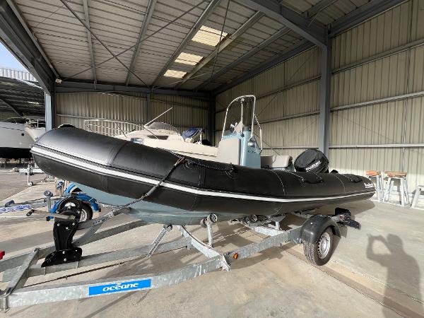 Bombard Explorer 550 2020 Bombard Explorer 550 inflatable boat on trailer in a storage facility.