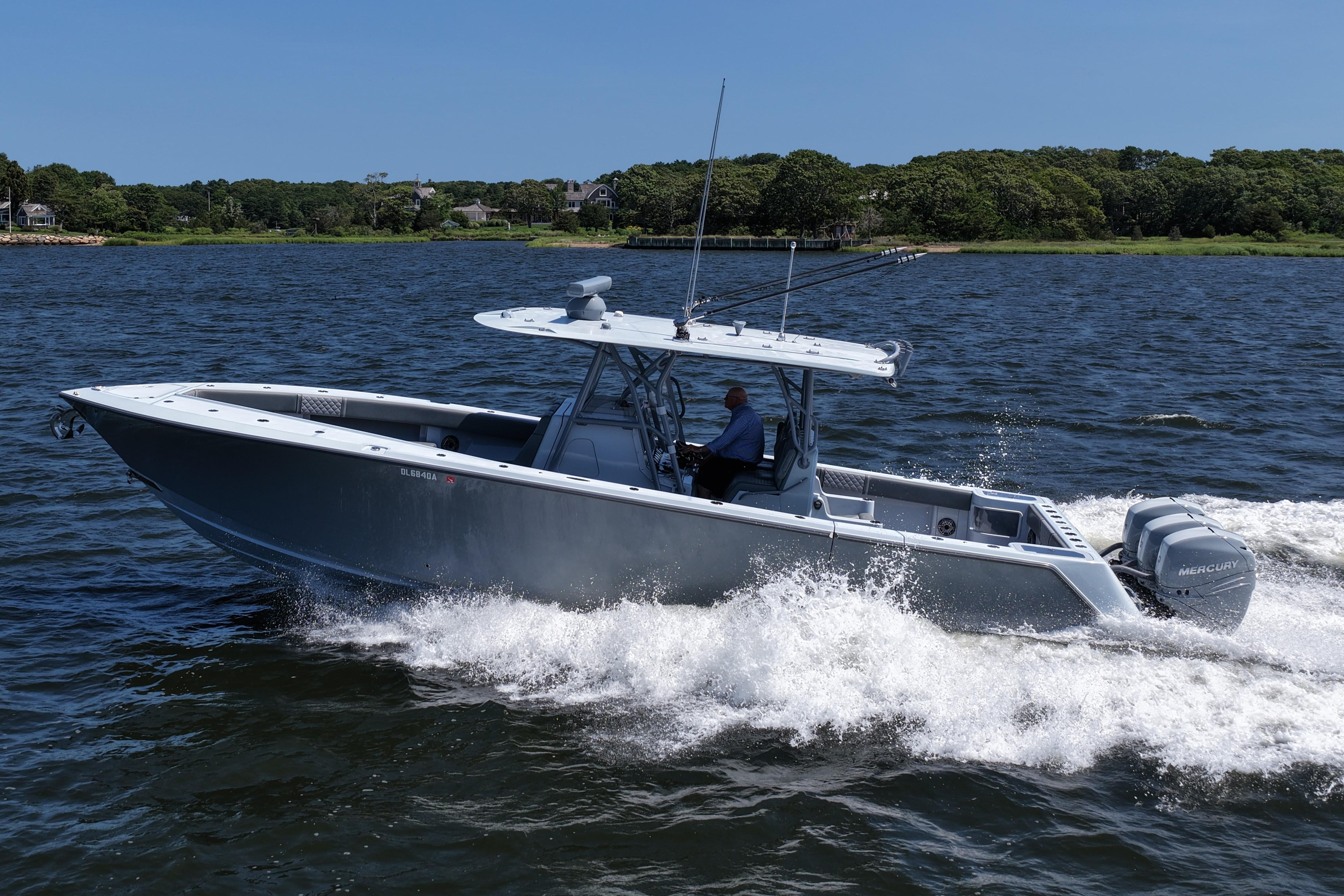 SeaVee 370z 2021 SeaVee 370z boat cruising on water with lush green shoreline in background.