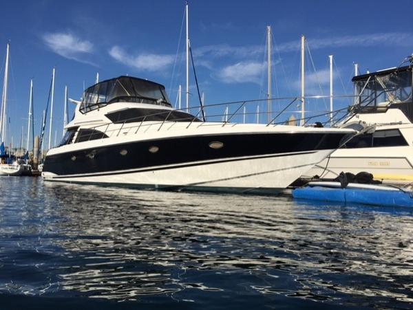Sunseeker Manhattan 1995 Sunseeker MANHATTAN yacht docked in marina, clear sky, calm water.