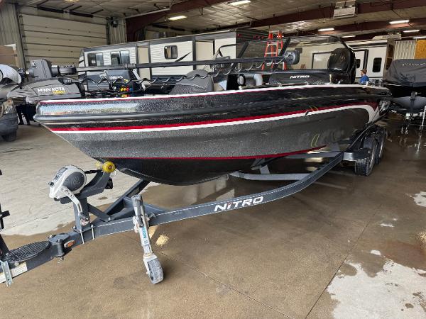 Nitro ZV21 2017 Nitro ZV21 boat in a garage, black with red accents, on a trailer.