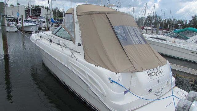 Sea Ray 340 Sundancer 2001 Sea Ray 340 Sundancer docked at marina with beige canopy.
