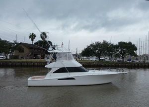 Viking 45 Convertible 2007 Viking 45 Convertible yacht on a calm river with overcast skies.