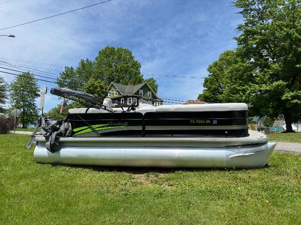 Sweetwater 2186 C 2019 Sweetwater 2186 C pontoon boat on grass, with trees and house in background.