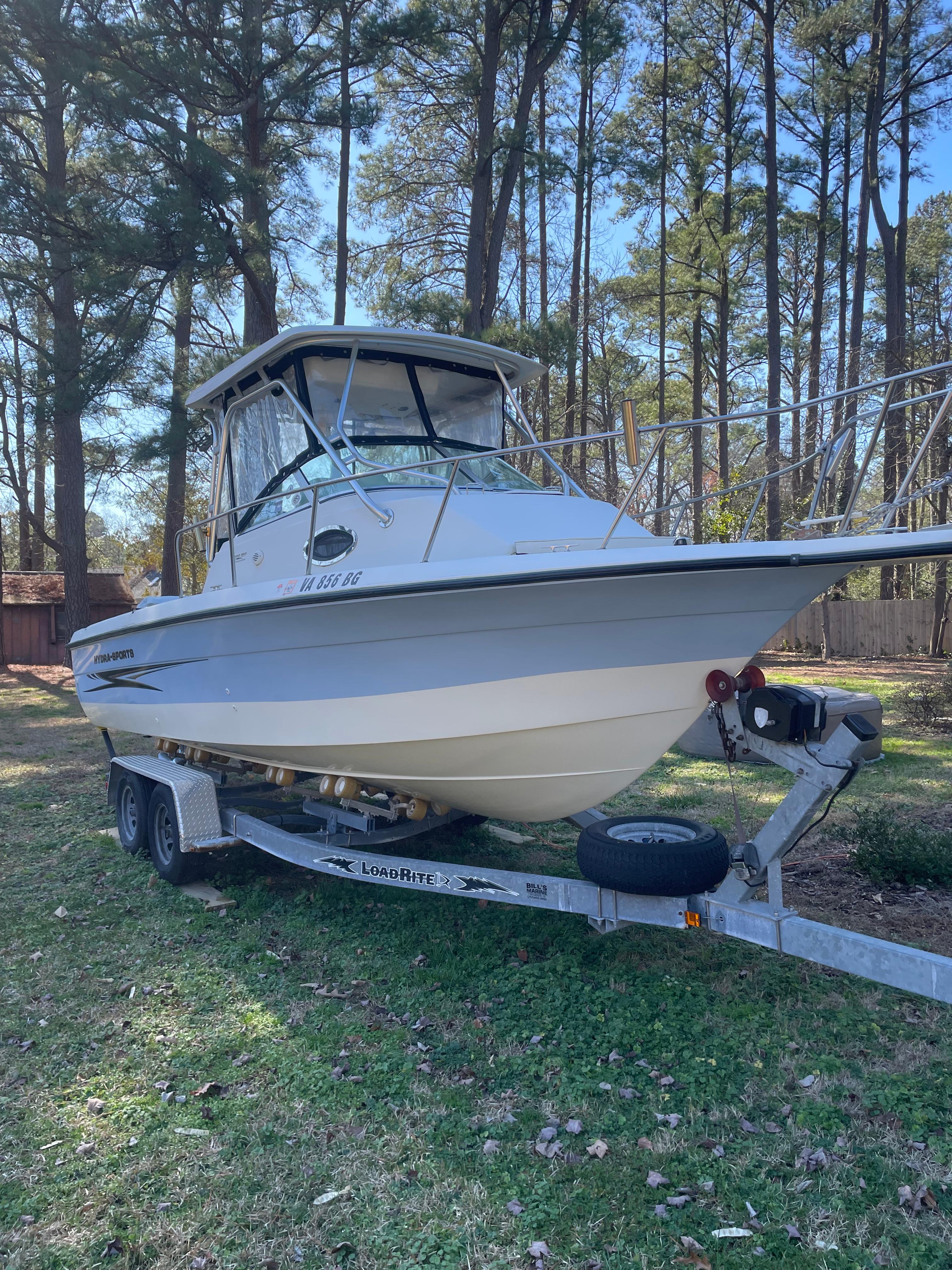Hydra-Sports 230 WA 2004 Hydra-Sports 230 WA boat on Load Rite trailer in wooded area.