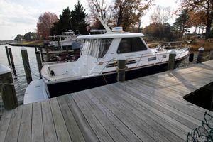 Sabre 38 Hardtop Express 2005 Sabre 38 Hardtop Express yacht docked at a serene marina.