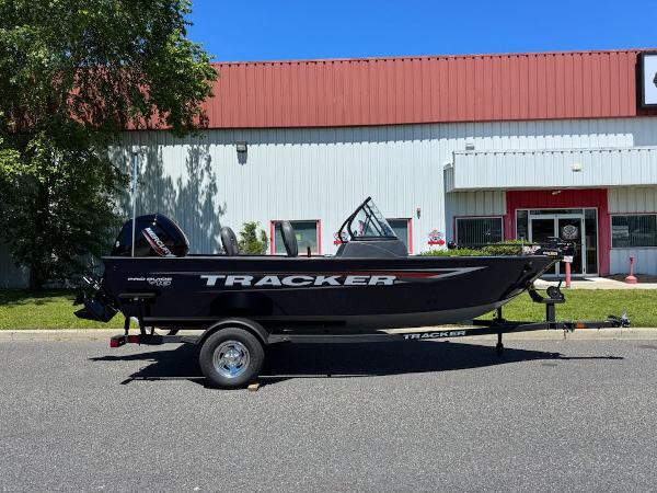 Tracker Pro Guide V-16 WT 2025 Tracker Pro Guide V-16 WT boat on trailer, parked outside a building.
