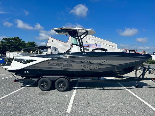Scarab 255 Open ID 2024 Scarab 255 Open ID boat on a trailer in a parking lot.