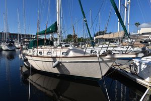 Island Packet 37 1995 Island Packet 37 sailboat docked in a marina, surrounded by other boats.