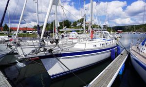 Hallberg-Rassy 40 2005 Hallberg-Rassy 40 sailboat docked in a marina under a partly cloudy sky.