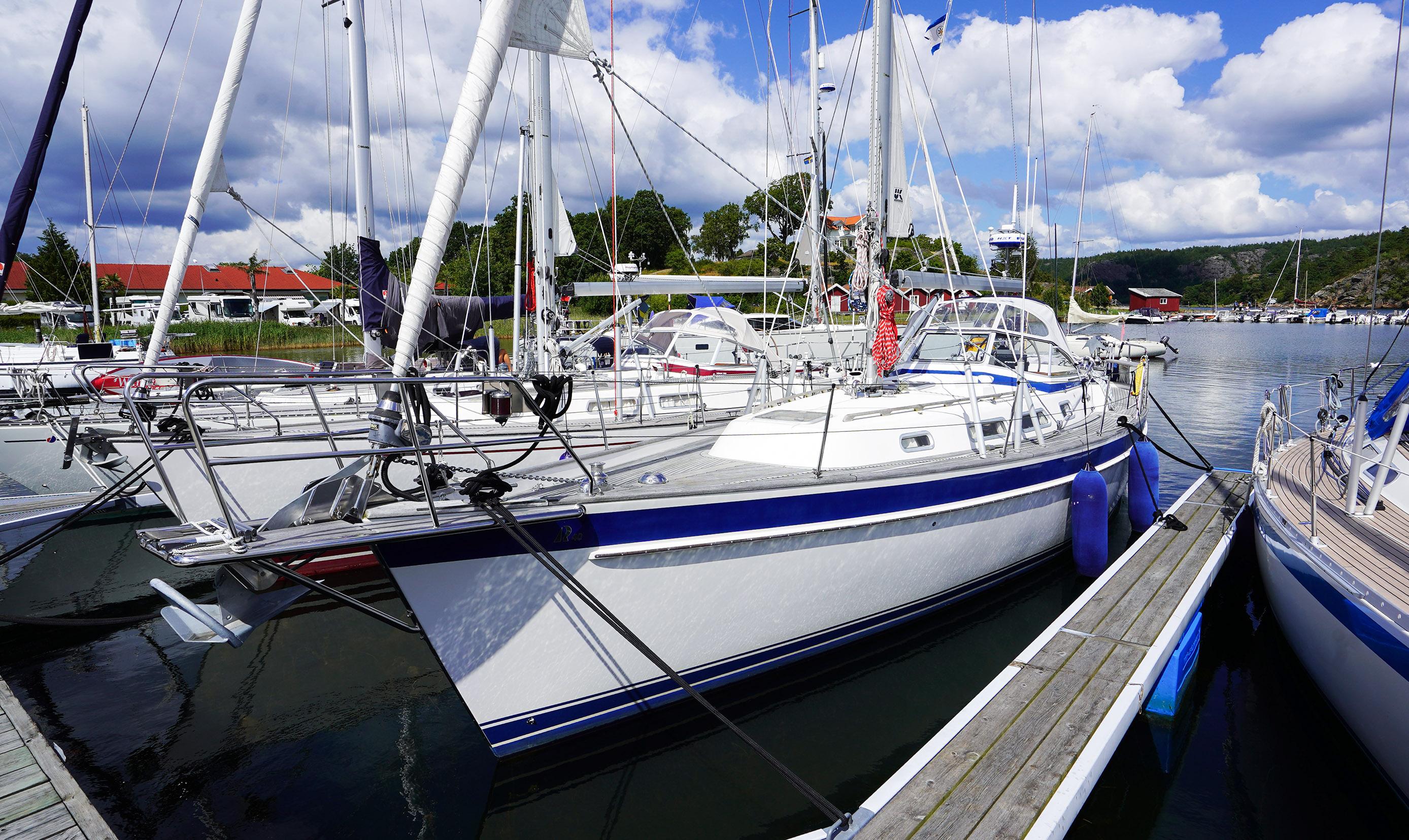 Hallberg-Rassy 40 2005 Hallberg-Rassy 40 sailboat docked in a marina under a partly cloudy sky.