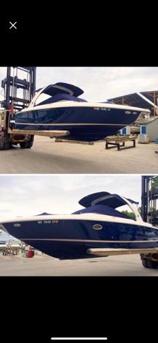 Regal 2700 ES Bowrider 2013 Regal 2700 ES Bowrider boat in a marina, elevated by a forklift.