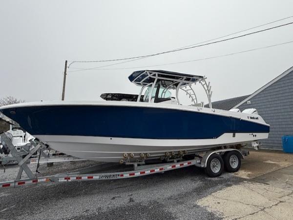 Wellcraft 302 Fisherman 2024 Wellcraft 302 Fisherman boat on trailer, blue and white design, parked outdoors.
