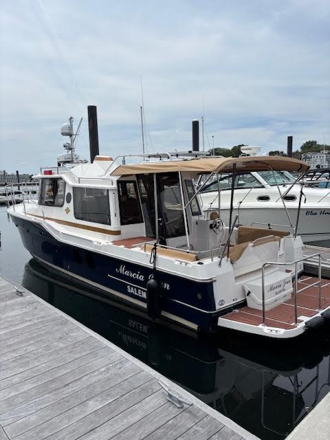 Ranger Tugs R-29 S 2023 Ranger Tugs R-29 S docked at marina, featuring sleek design and spacious deck.