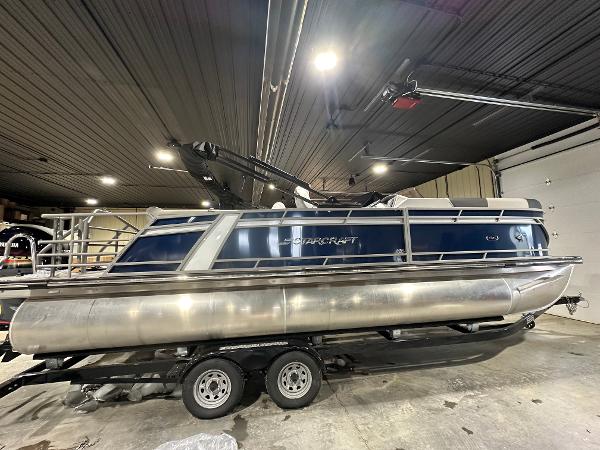 Starcraft CX 23 DL 2024 Starcraft CX 23 DL pontoon boat in indoor storage.