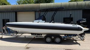 Iron 707 T-Top 2024 Iron 707 T-Top boat on trailer, parked outside industrial building.