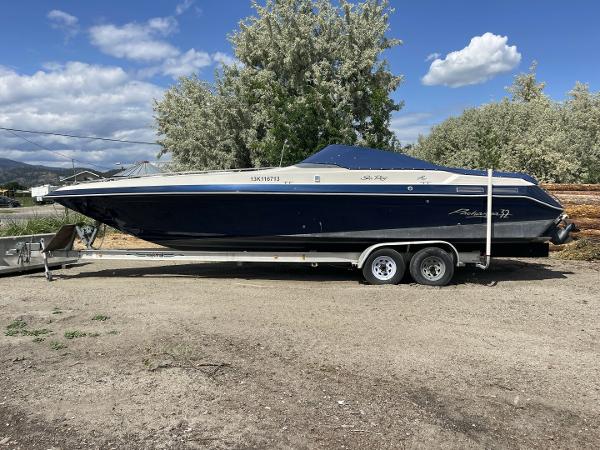 Sea Ray Pachanga 1987 Sea Ray PACHANGA boat on trailer, parked outdoors under a blue sky.