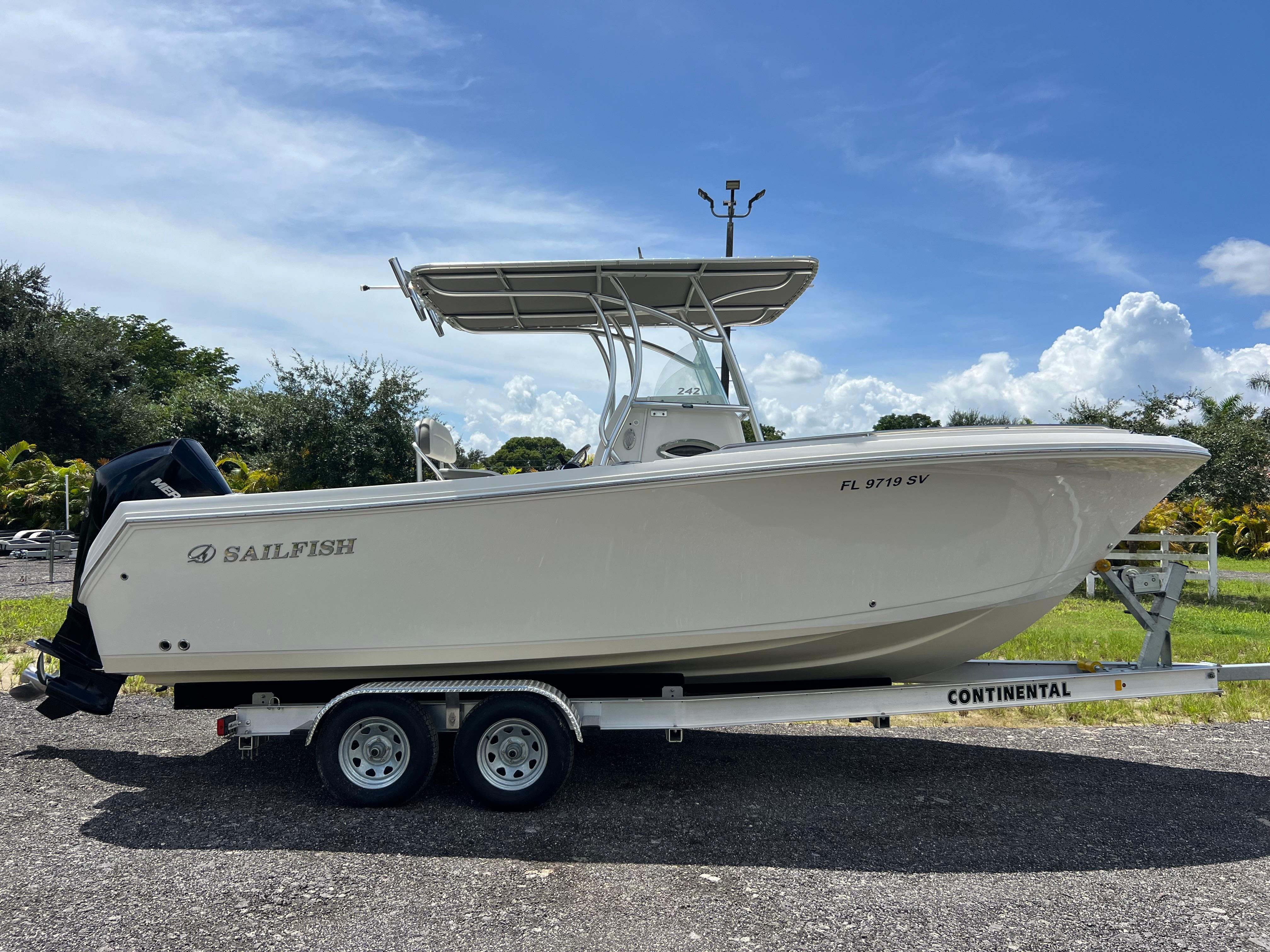 Sailfish 242 CC 2021 Sailfish 242 CC boat on trailer, parked outdoors under a clear sky.