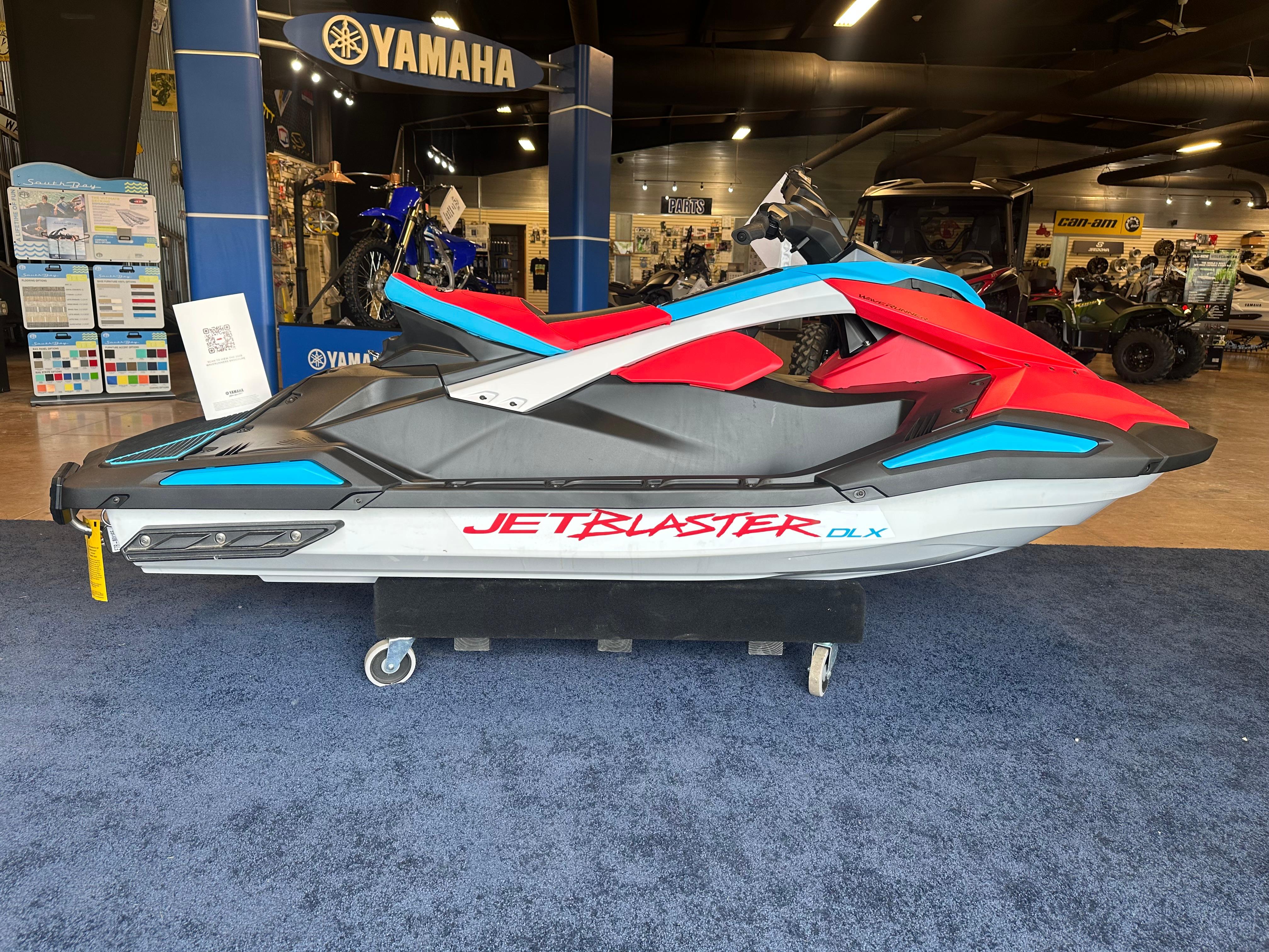 Yamaha WaveRunner JetBlaster DLX 2-Up 2025 Yamaha WaveRunner JetBlaster DLX 2-Up in showroom, vibrant red and blue design.