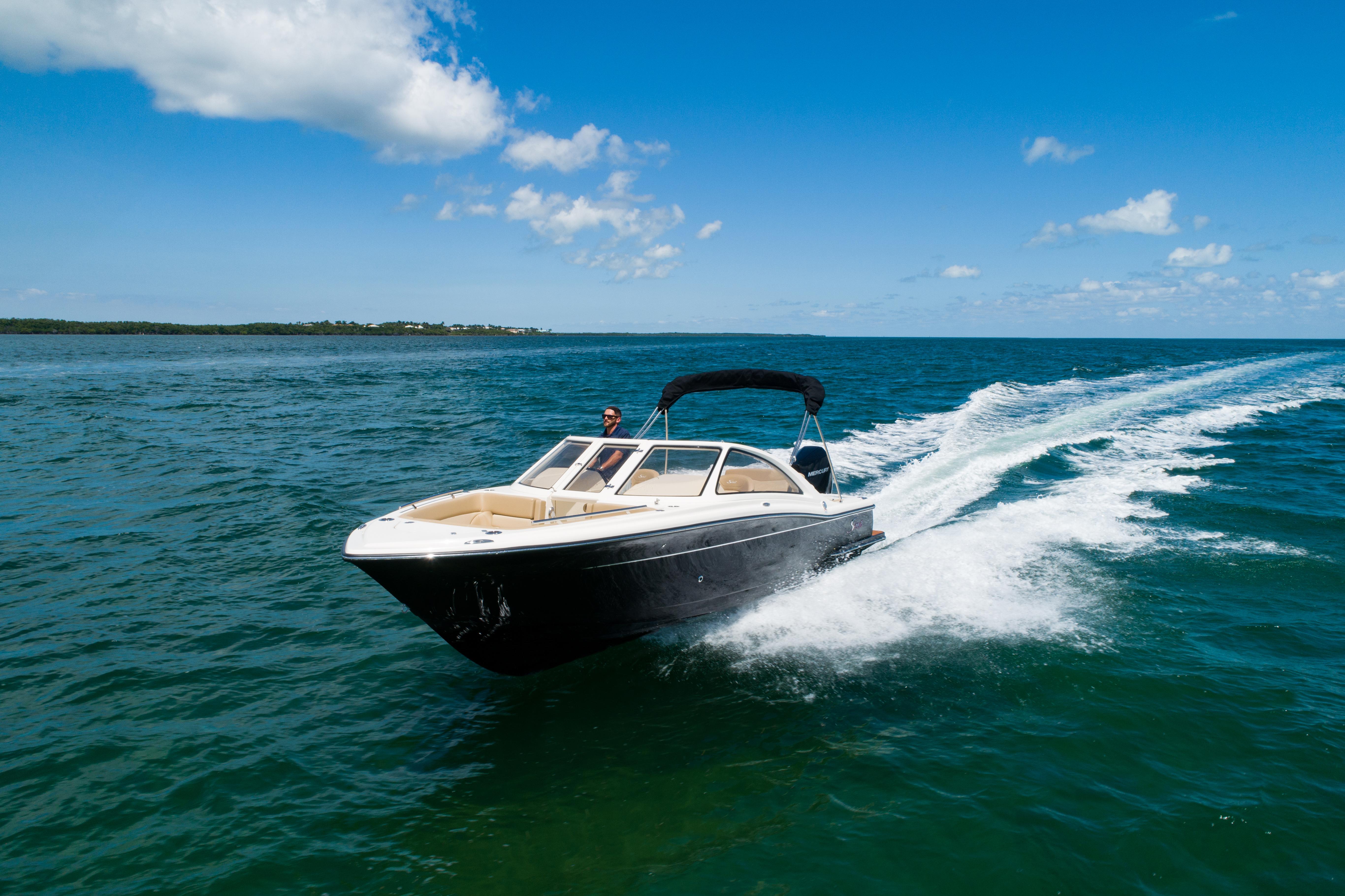 Scout 240 Dorado 2025 Scout 240 Dorado boat cruising on open water under a clear blue sky.