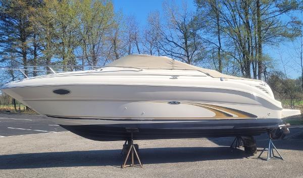 Sea Ray 245 Weekender 2001 Sea Ray 245 Weekender boat on stands, surrounded by trees.