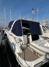 Innovazione e Progetti Mira 43 2003 Innovazione e Progetti Mira 43 yacht docked with blue canopy and flags.