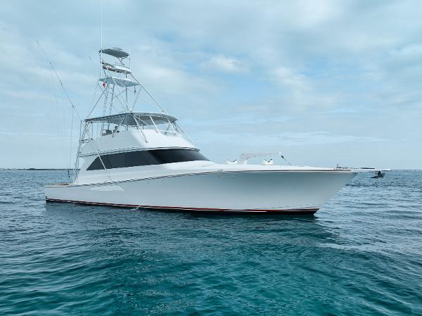 Viking 65 2001 Viking 65 yacht on calm ocean waters under a cloudy sky.