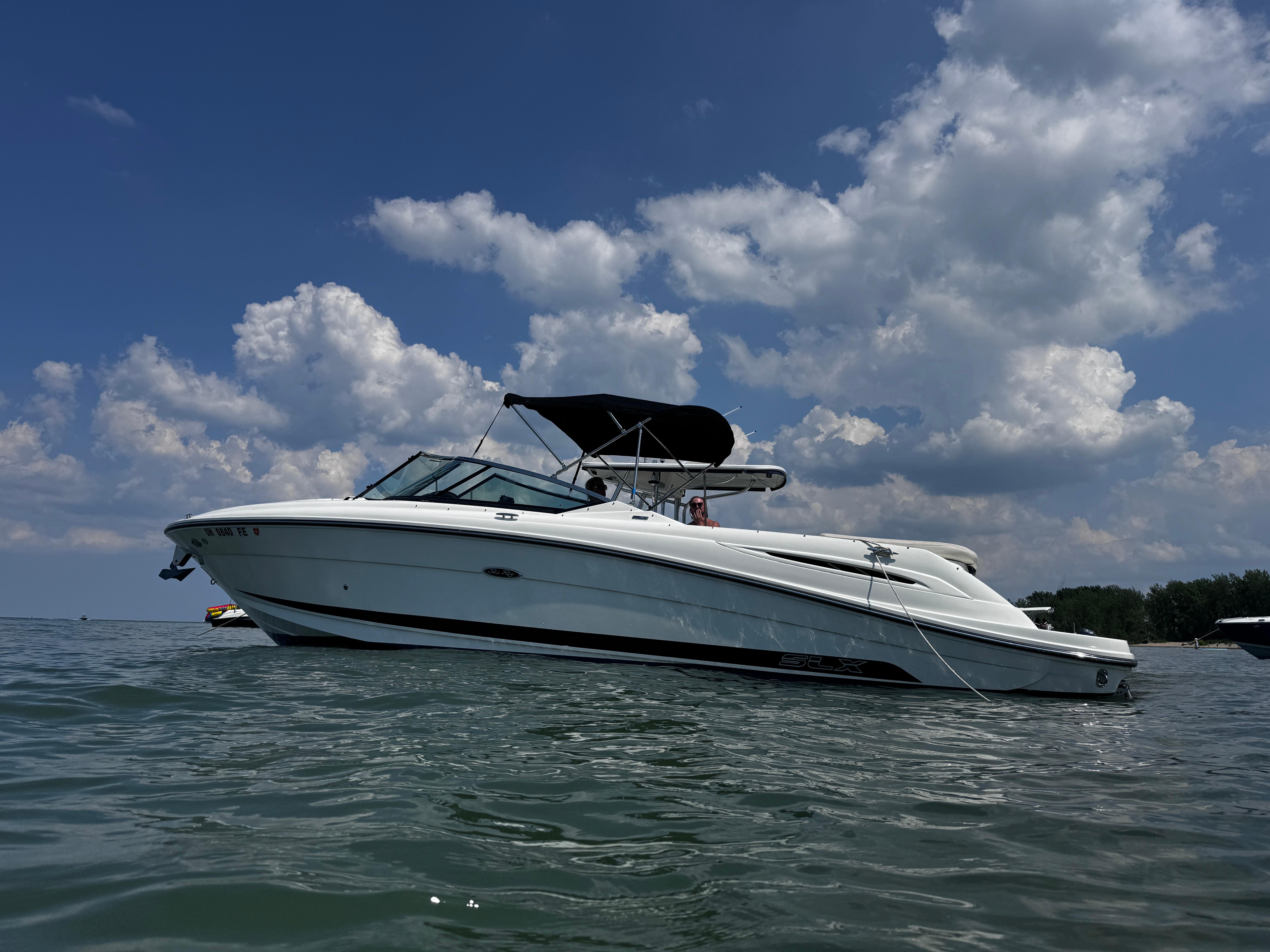 Sea Ray 270 SLX 2007 Sea Ray 270 SLX boat on calm water under a partly cloudy sky.