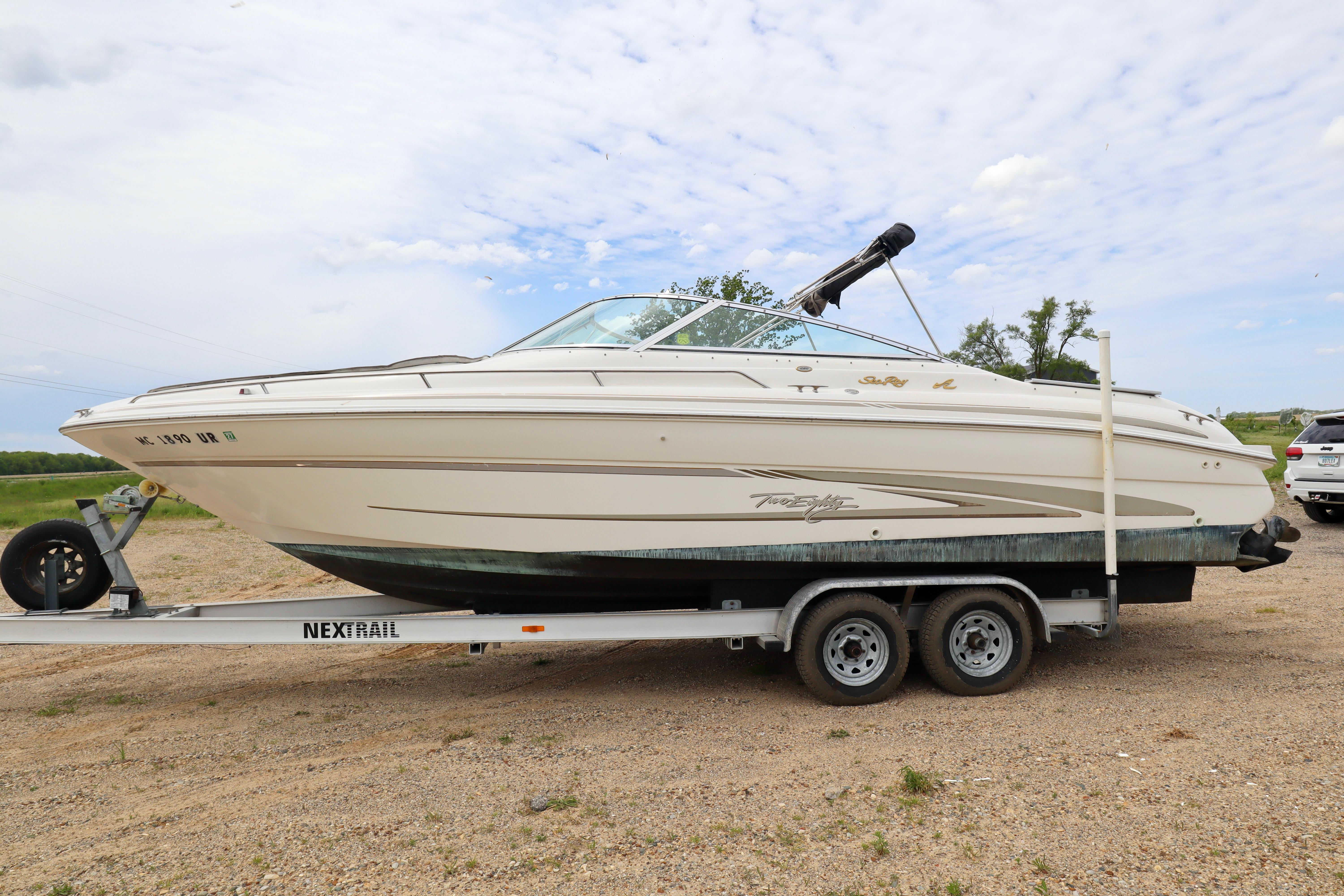 Sea Ray 280 Bowrider 1997 Sea Ray 280 Bowrider on trailer, parked outdoors under a cloudy sky.