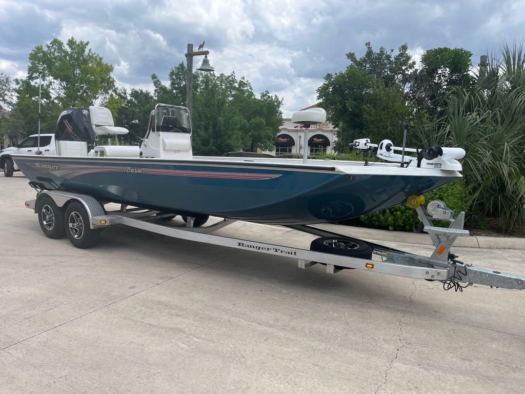 Ranger RB210 2025 Ranger RB210 boat on trailer, parked outdoors under cloudy sky.