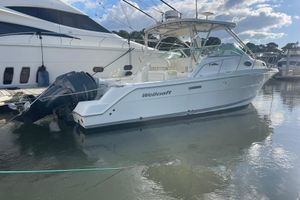 Wellcraft 290 Coastal 2005 Wellcraft 290 Coastal boat docked in marina, featuring dual outboard engines.