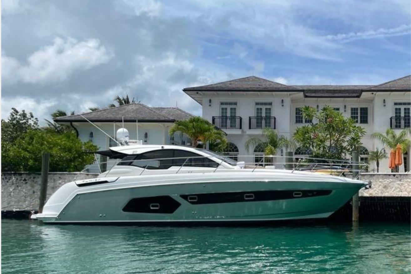 Azimut Atlantis 43 2020 Azimut Atlantis 43 yacht docked by a luxurious waterfront villa.
