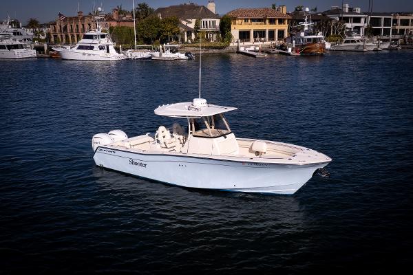 Grady-White 30.6 Canyon 2022 Grady-White 30.6 Canyon boat on calm water, with marina background.