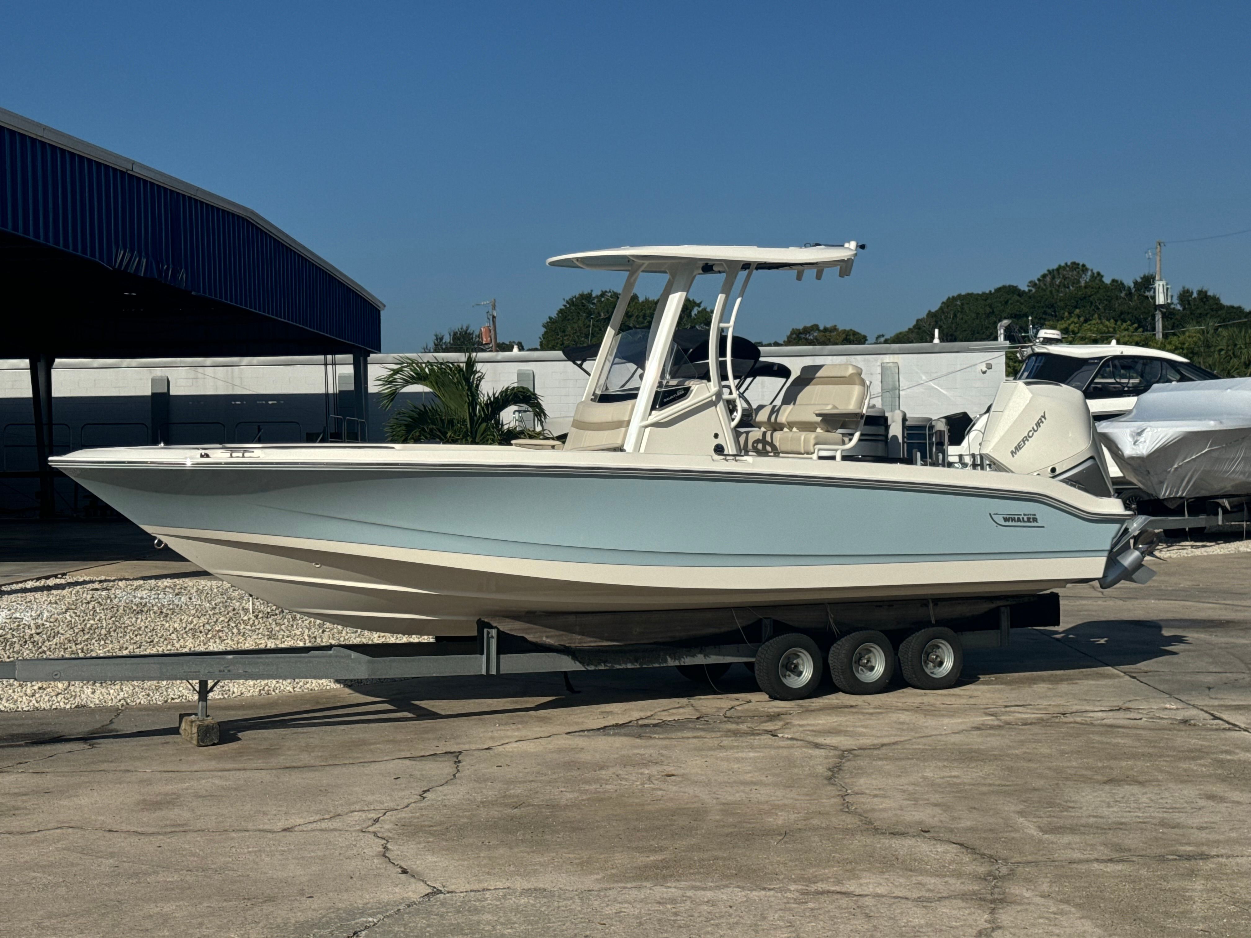 Boston Whaler 250 Dauntless 2025 Boston Whaler 250 Dauntless boat on trailer, parked outdoors.