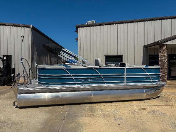 Trifecta 22 RF LE 2025 Trifecta 22 RF LE pontoon boat with blue exterior, parked outdoors.