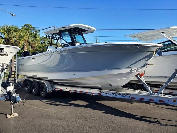 Blackfin 302CC 2023 Blackfin 302CC boat on a trailer in a marina.