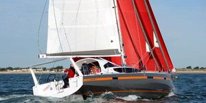 Sailboat JPK 45 FC 2023 JPK 45 FC sailboat with red sails navigating on open water.
