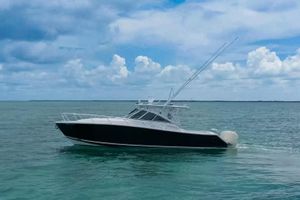 Jupiter 39 Express 2009 Jupiter 39 Express boat cruising on calm ocean waters under a cloudy sky.