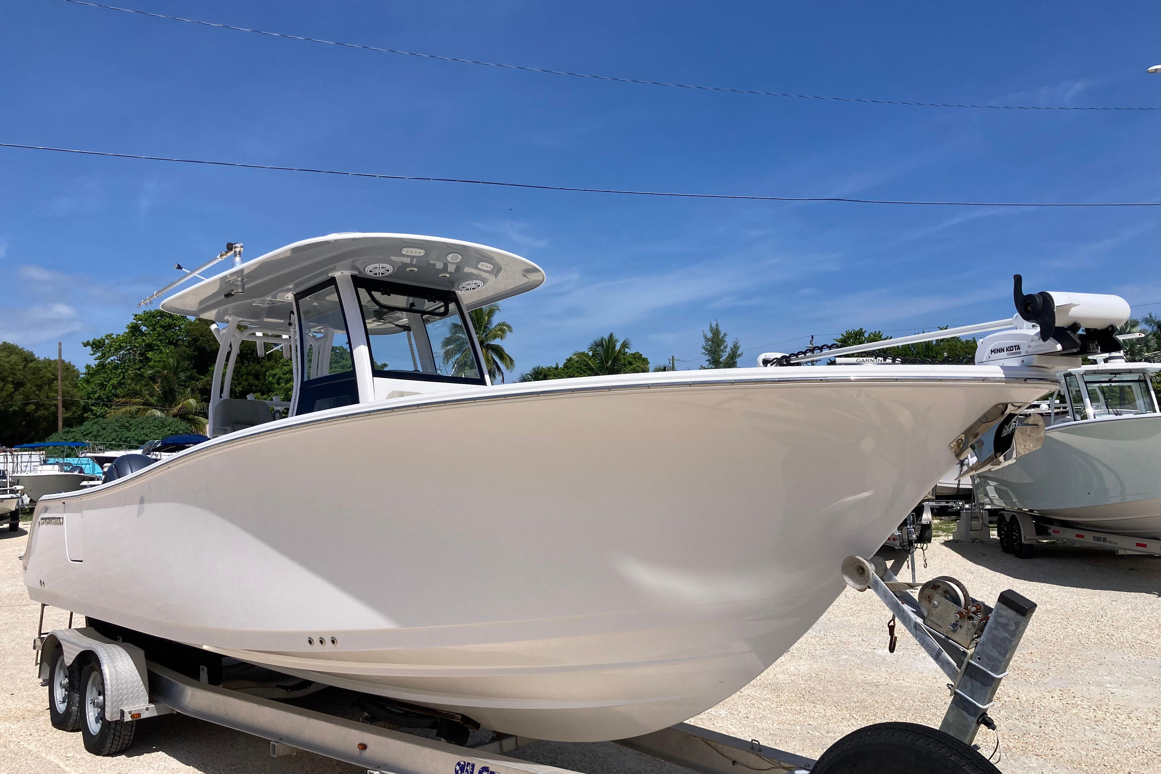 Sportsman Open 282TE Center Console 2023 Sportsman Open 282TE Center Console boat on trailer, sunny day.