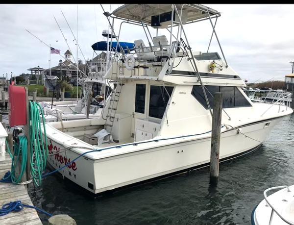 Hatteras 38 Convertible Must Sell.. MAKE OFFER NOW ! 1988 Hatteras 38 Convertible yacht docked at marina, side view.