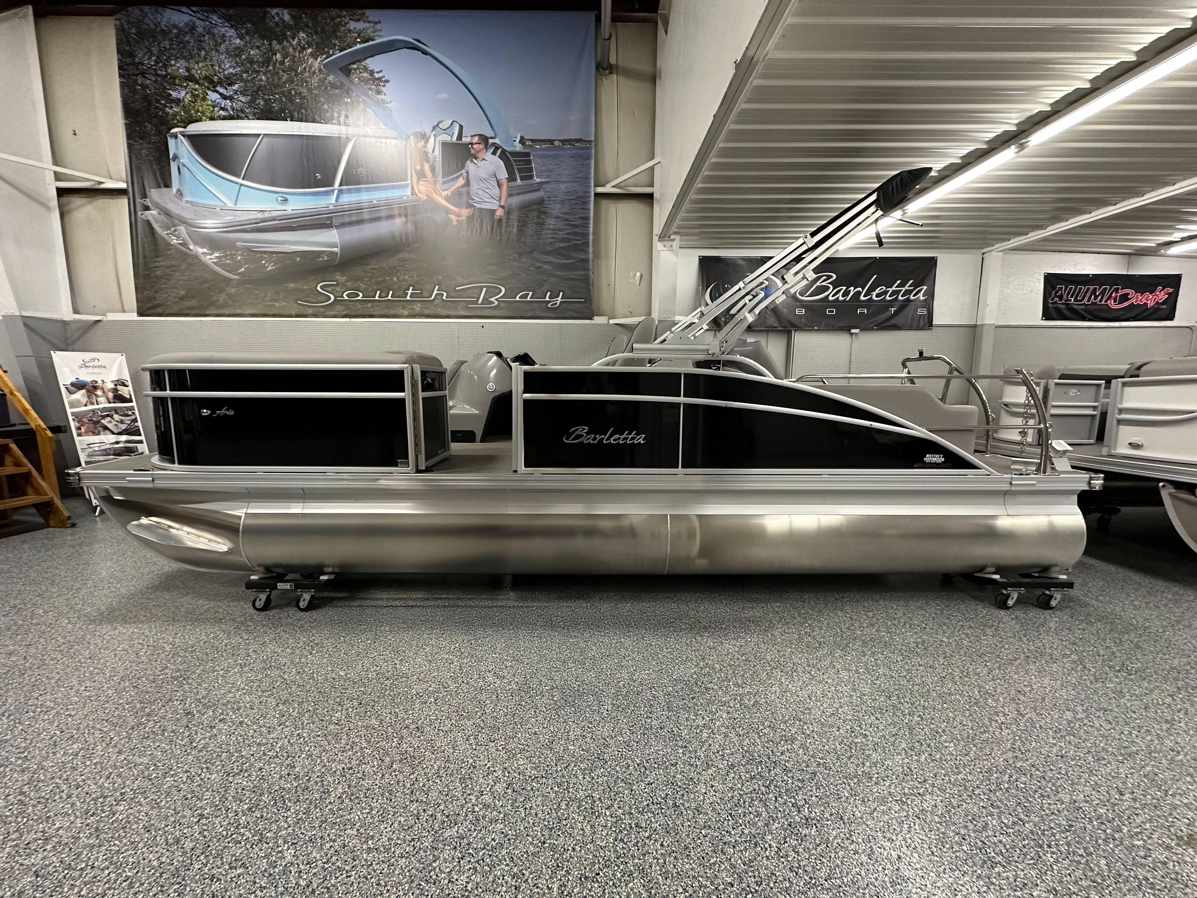 Barletta ARIA 22UC 2025 Barletta ARIA 22UC pontoon boat displayed in showroom with sleek design.