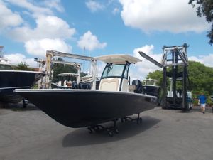 Scout 251XSS 2025 Scout 251XSS boat on a trailer at a marina.