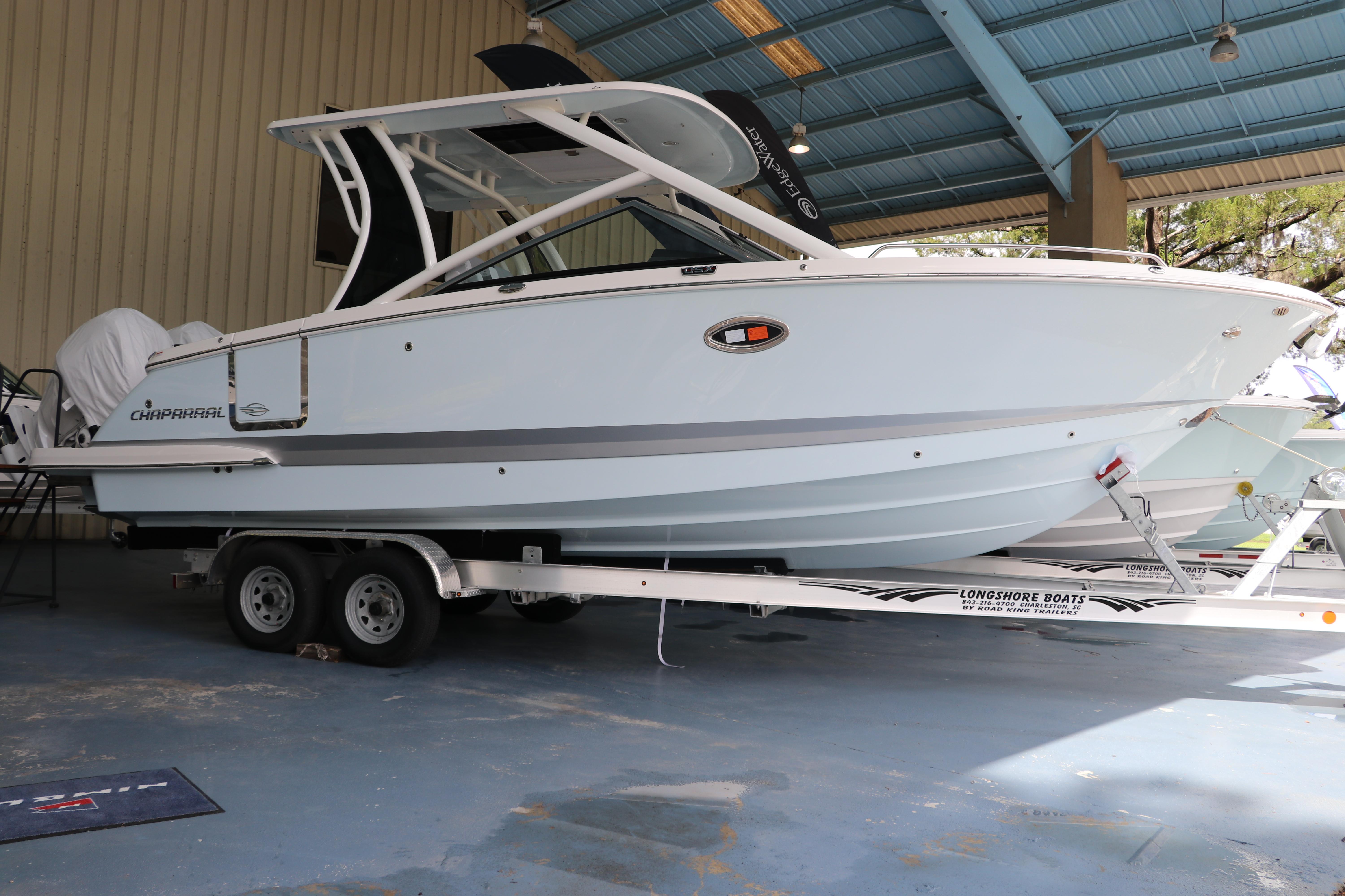 Chaparral 280 OSX 2025 Chaparral 280 OSX boat on trailer in covered storage area.