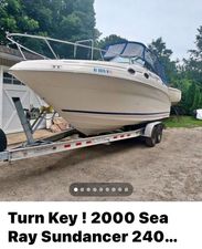 Sea Ray 240 Sundancer 2000 Sea Ray 240 Sundancer boat on trailer, parked outdoors.