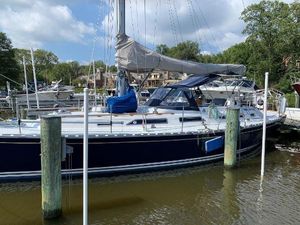 Hylas 44 Sailboat docked at marina, Hylas 44 model, 1990, with blue hull and covered sails.